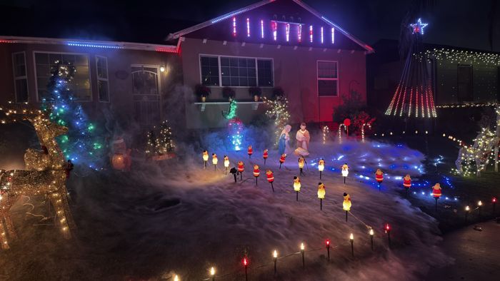 Fog drifting across the yard between candy-cane lights, reindeer and the pixel tree