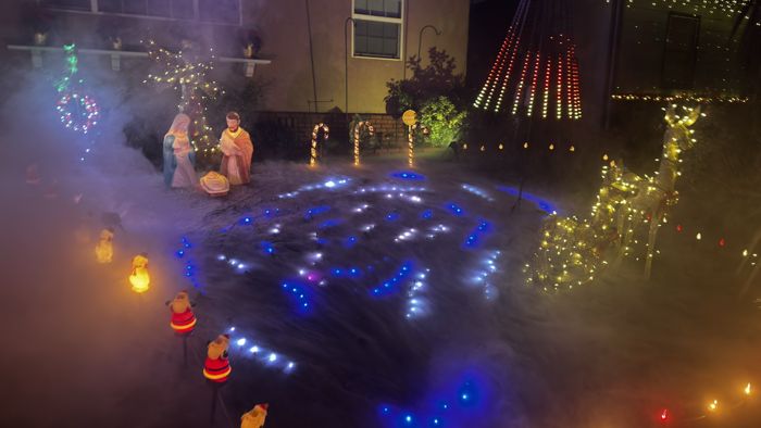 The nativity scene with lights shining through the fog