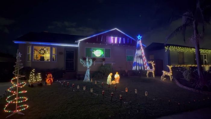 The house with a red, white and blue pixel tree and glowing nativity